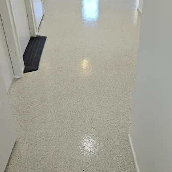 Speckled cream hard floor in a hallway after cleaning