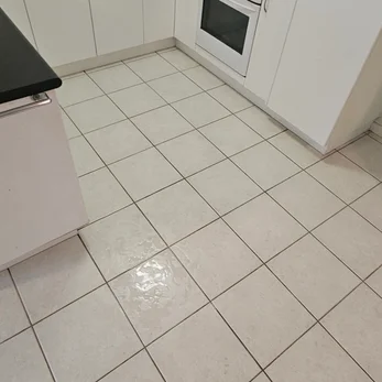 White kitchen floor tiles with clean grout lines